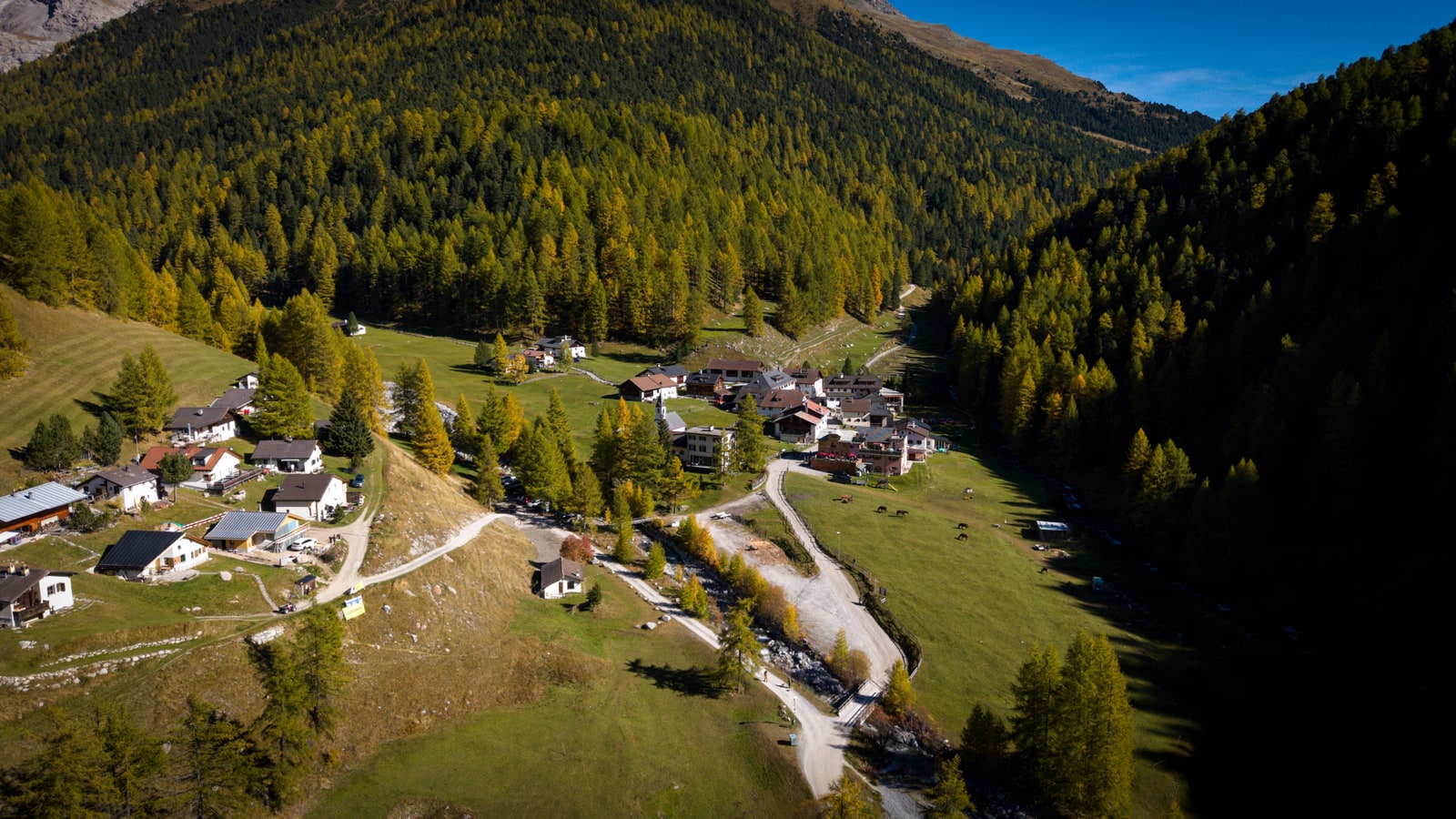Expansive landscape composition showing the contrast between cultivated land and wild terrain from drone altitude